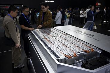 People look at a model of CATLs Qilin Condensed Battery during the CATL Tech Day event ahead of the Beijing Auto Show in Beijing on April 21, 2026. (Photo by WANG Zhao / AFP)