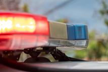 The emergency lights on a police vehicle of the New South Wales Police Force parked at the corner of Carrington Road and Pine Street, Randwick, at the scene of a motor vehicle accident. This image was taken on a hot and sunny morning on 8 February 2025.