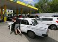A driver pushes his car to a petrol station trying to buy fuel in Odesa, Ukraine 18 May 2022. Private public transport companies of Odesa have reduced the number of exits of their buses on routes due to lack of gasoline, according to local media. The operational headquarters under the Cabinet of Ministers decided to abandon state regulation of fuel prices, media reported on 17 May, referring to the Minister of Economy. Long queues have formed for petrol stations in Ukraine, as the country have fuel shortages, amid Russian invasion in Ukraine. (Photo by STR/NurPhoto via Getty Images)